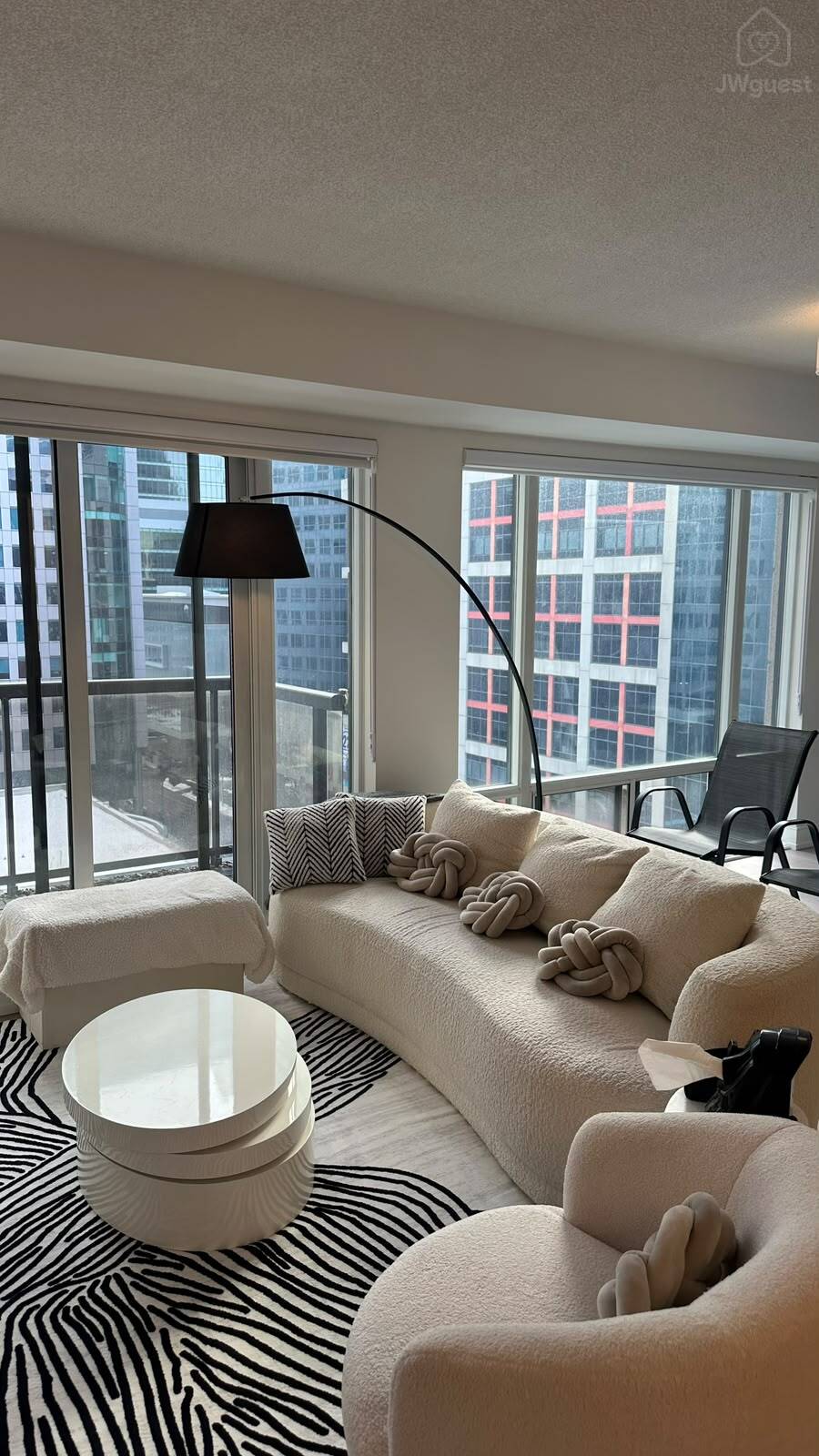 Comfortable lounge seating with large windows and city views — Downtown Toronto Stay | Steps from CN Tower & King West, Toronto, Ontario