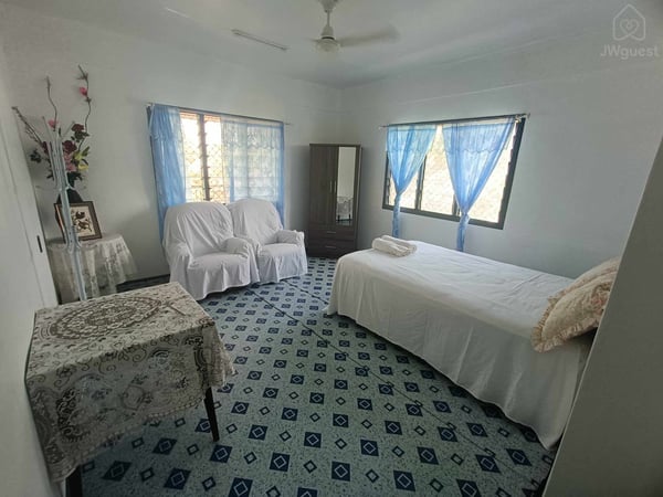 Large bedroom with queen bed and portable airconditioner, wardrobe and couches (single bed able to be added to room if… — Shared island home in beautiful Samoa - 2, Apia, Upolu