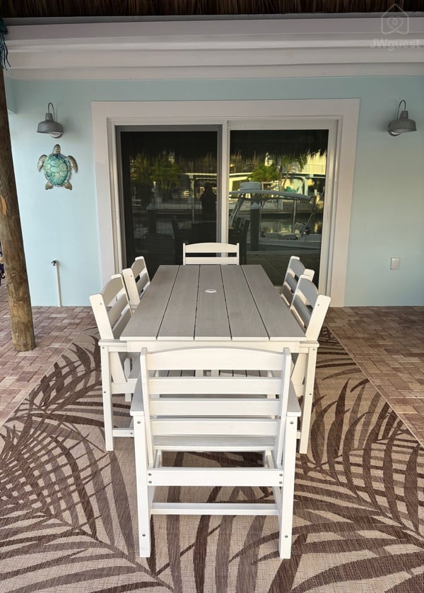 Outdoor dining — Waterfront 3BR 3BA with 37 ft Dock Tiki Hut Access to Club Pool, Key Colony Beach, Florida