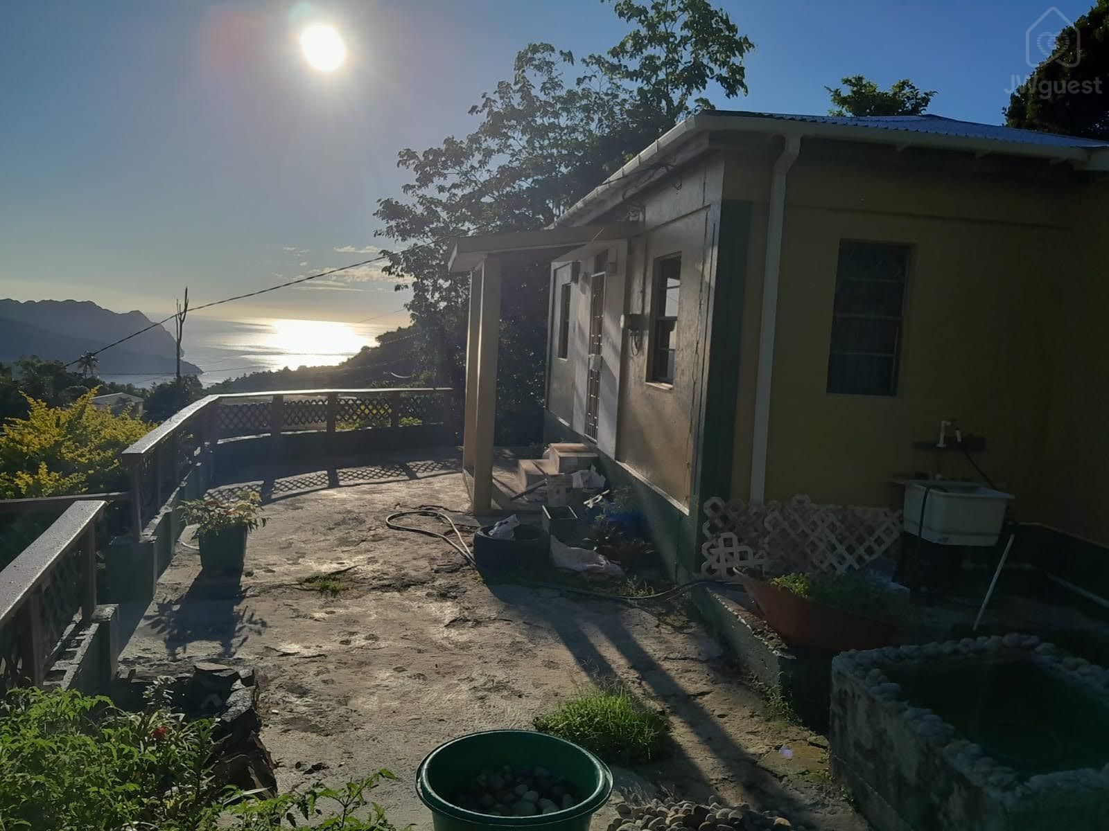 That is the morning sun coming up from the horizon! Fishpond was under construction.. — Sunrising Breeze at Grand Bay Dominica, Saint Patrick Parish