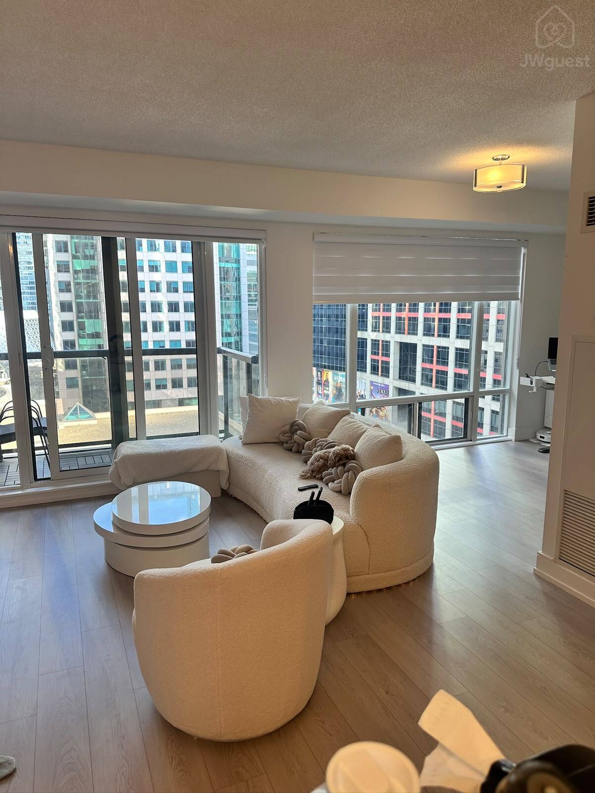 Spacious living room surrounded by large windows and natural light — Downtown Toronto Stay | Steps from CN Tower & King West, Toronto, Ontario