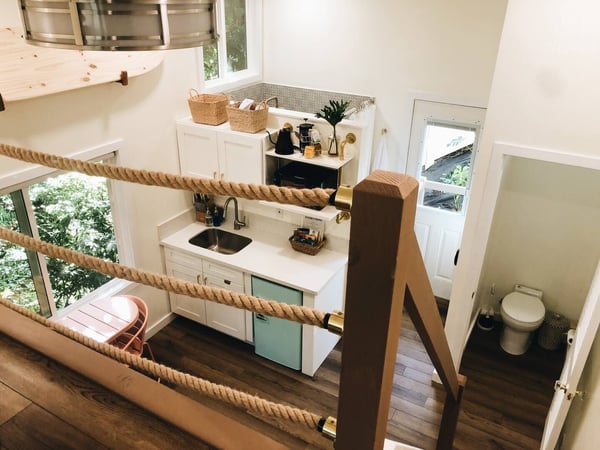A view from the bedroom loft looking down onto the open, airy treehouse apartment — Elevated Jungle Treehouse with Loft BR, Mililani, Hawaii