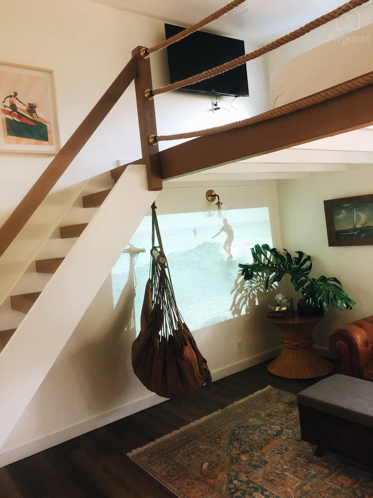 Take the stairs up to the loft bedroom equipped with a wall mounted 42" TV equipped with Amazon FireStick — Elevated Jungle Treehouse with Loft BR, Mililani, Hawaii