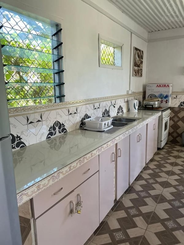 Kitchen area with gas stove and fridge — Shared island home in beautiful Samoa - 2, Apia, Upolu