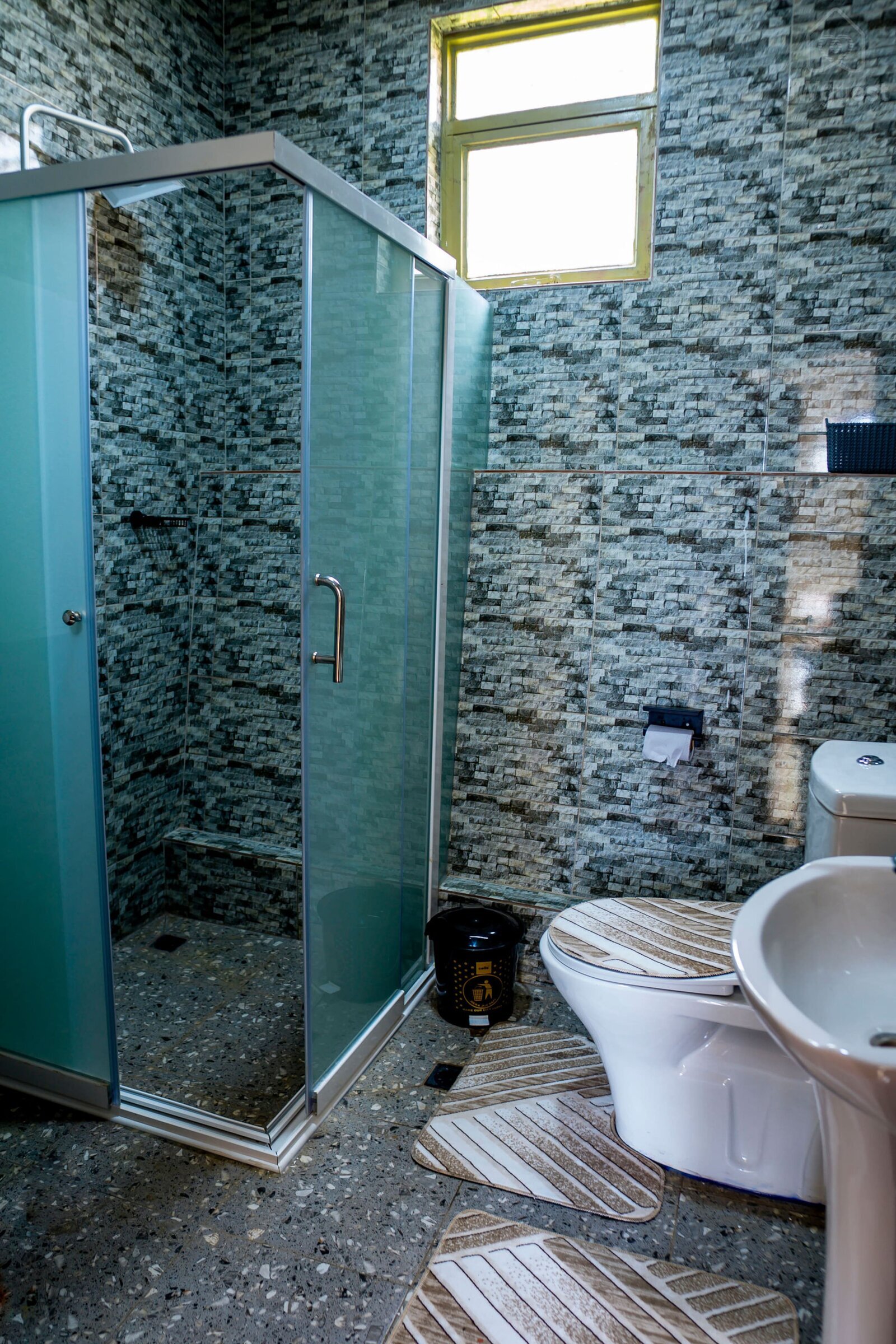 Bathroom 2 - newly renovated with a shower head and shower cubicle for your comfort and ease. — Cozy 2-Bedroom Haven Near KGL Airport - Valley View, Kigali, Kigali City