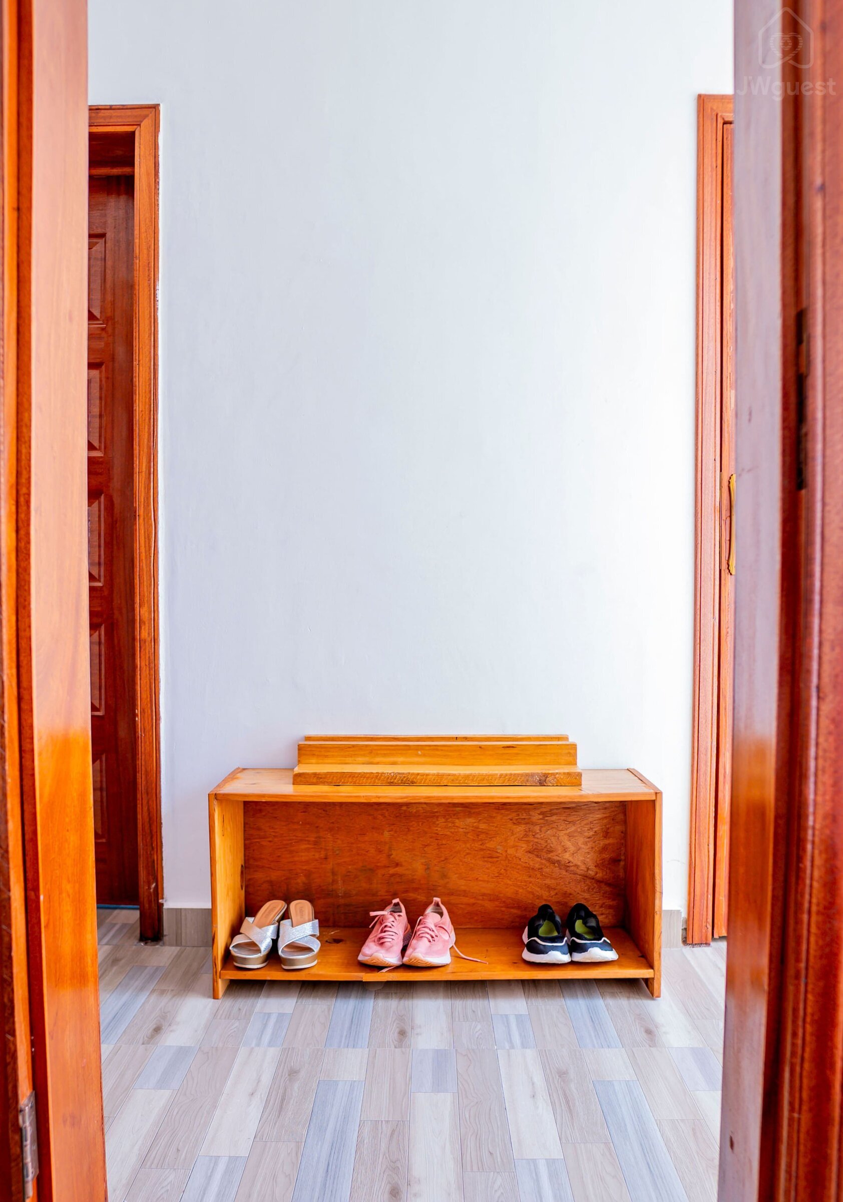 Corridor to the rooms - shoe shelf - view from ensuite bedroom 1 — Cozy 2-Bedroom Haven Near KGL Airport - Valley View, Kigali, Kigali City