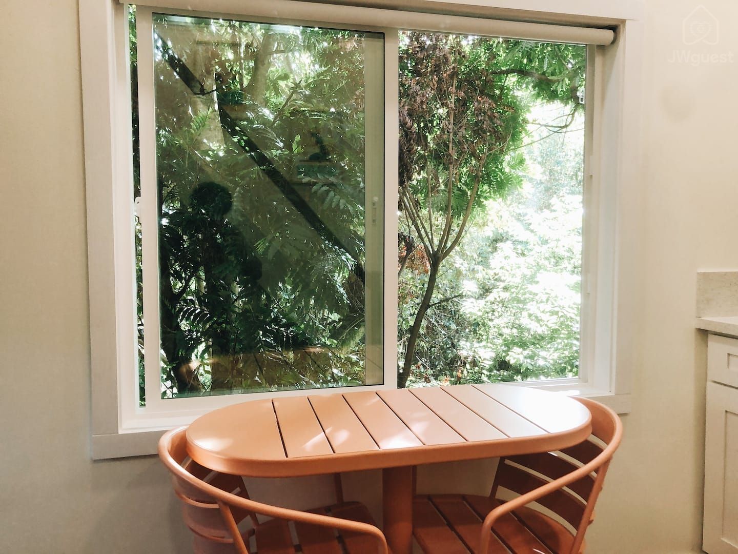 Dine together at the chic café style table overlooking the lush trees outside — Elevated Jungle Treehouse with Loft BR, Mililani, Hawaii