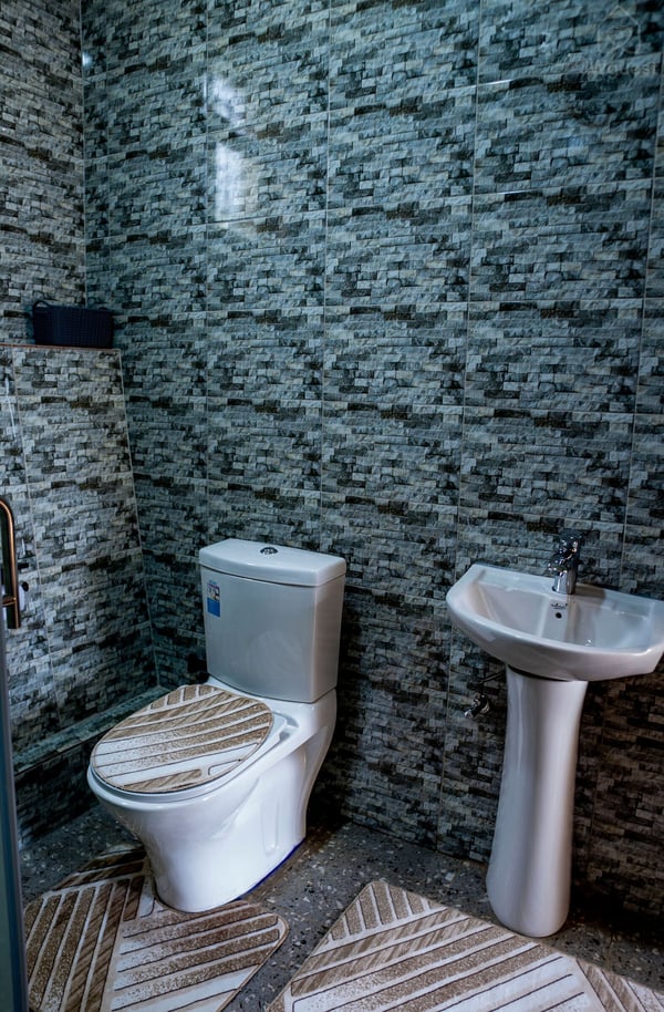 Bathroom 2 - newly renovated with a shower head and shower cubicle for your comfort and ease. — Cozy 2-Bedroom Haven Near KGL Airport - Valley View, Kigali, Kigali City
