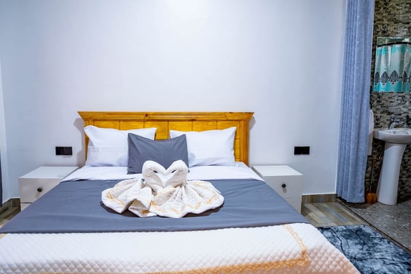 Bedroom 1 - ENSUITE With a comfortable bed, newly furnished for your comfort and cozy sleep. There are also two bed… — Cozy 2-Bedroom Haven Near KGL Airport - Valley View, Kigali, Kigali City