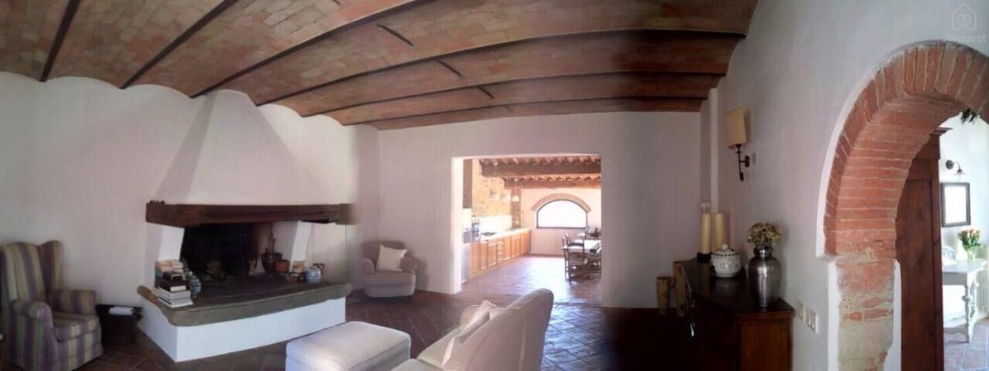 There is a living room for shared use that features a comfortable fireplace. — The Barn under the Tuscan countryside, Tavarnelle, Toscana