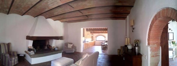 There is a living room for shared use that features a comfortable fireplace. — The Barn under the Tuscan countryside, Tavarnelle, Toscana