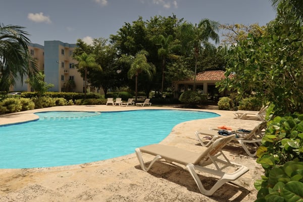 Elegant outdoor pool perfect for morning swims or relaxing evenings. — Exclusive apartment ideal for short and long stay in Punta Cana, Punta Cana, La Altagracia