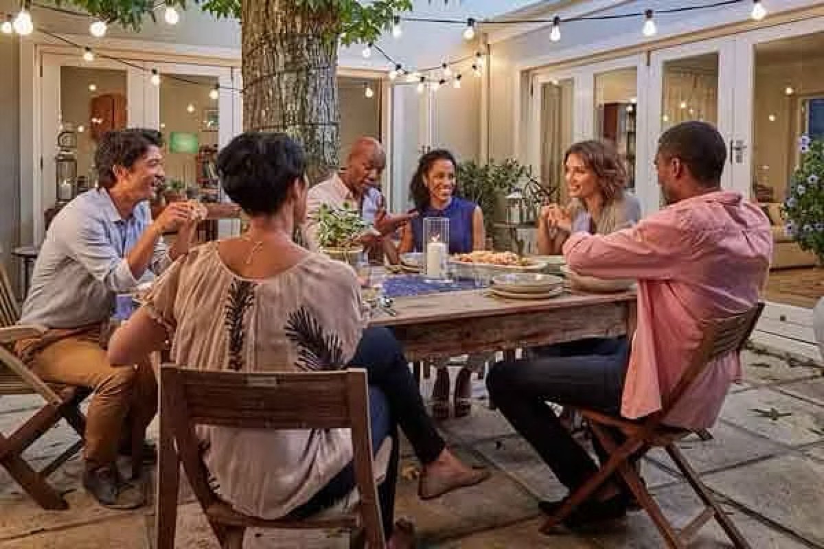 Friends sharing a meal together around a table